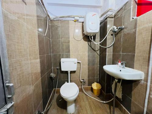 a bathroom with a toilet and a sink at Ssexotica in Patna