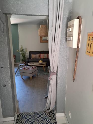- une vue sur le salon par une porte dans l'établissement La Bohème appartement, à Tournon-sur-Rhône