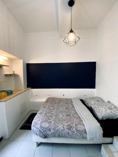 - une chambre avec un lit et un mur noir dans l'établissement Loft au coeur du centre historique, à Narbonne