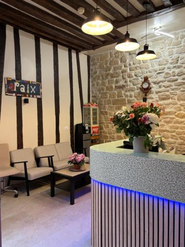 Coin salon dans l'établissement Hôtel Des Fontaines