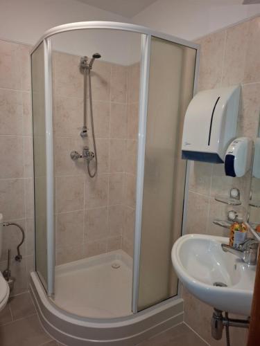 a bathroom with a shower and a sink at Duets in Daugavpils