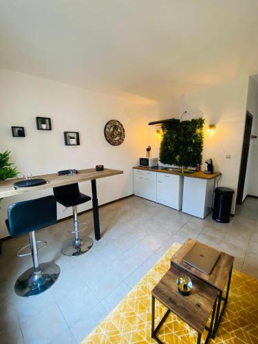 un salon avec une table et une cuisine dans l'établissement Logement coeur de ville, à Narbonne
