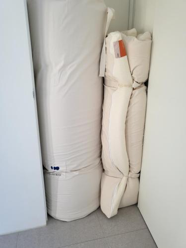 a couple of white mattresses sitting in a closet at Stay D in Goseong