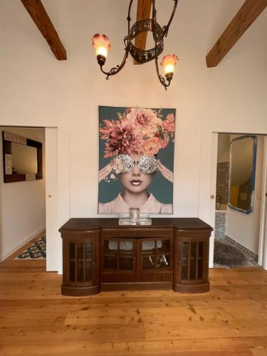 a room with a painting on the wall and a table at Villa Bella Vita in Seeboden