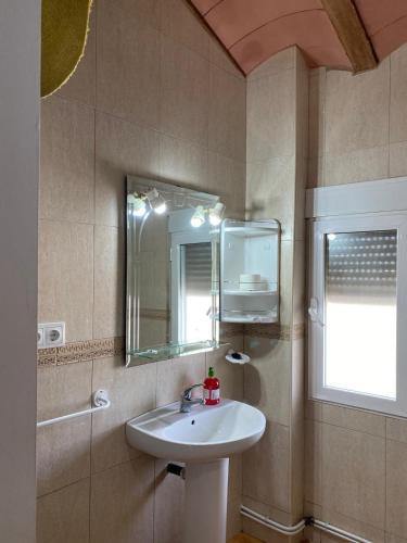 a bathroom with a sink and a mirror at Vivienda Turística de Alojamiento Rural "El Pino" in Pozo Alcón