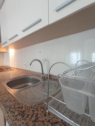 a kitchen counter with a sink and a faucet at Antalya Apart in Antalya