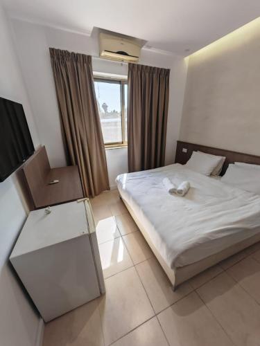 a hotel room with a bed and a window at New Metropole Hotel - Jerusalem in Jerusalem