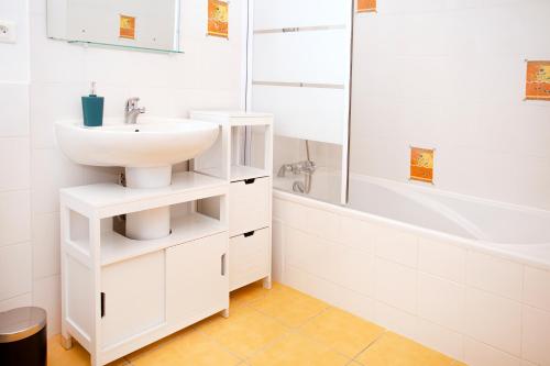a white bathroom with a sink and a shower at La Mancellière de Montjoie chambres d'hôtes et gîtes in Saint-Michel-de-Montjoie