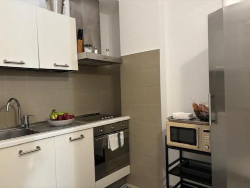 a kitchen with a sink and a stove top oven at Medea Mondello Holiday in Mondello