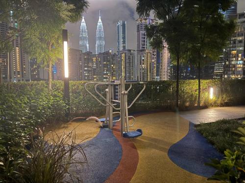 a playground in a city with a city skyline at Eaton Residences KLCC By ARBAN in Kuala Lumpur