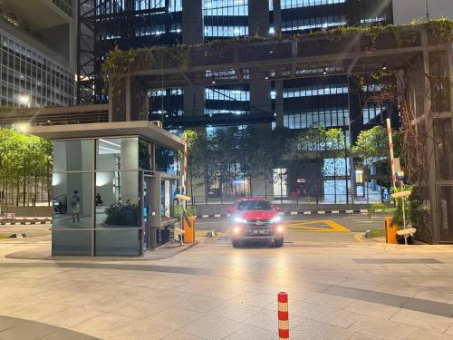 a car driving down a city street at night at Eaton Residences KLCC By ARBAN in Kuala Lumpur
