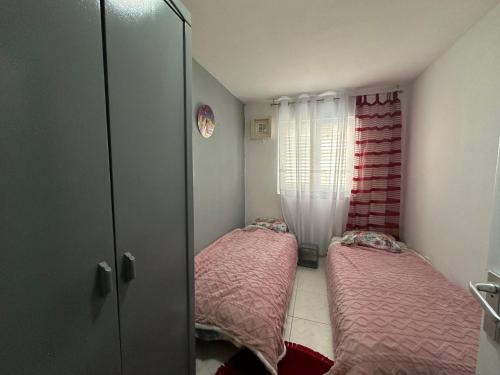 En eller flere senge i et værelse på Apartman Nenezic