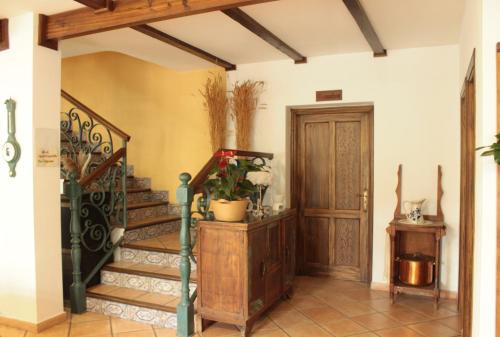 a hallway with a staircase and a wooden door at Rural Coliving in Pontevedra