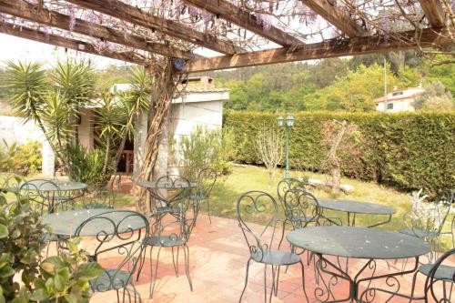 a group of tables and chairs in a garden at Rural Coliving in Pontevedra