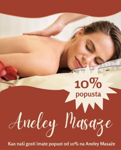 a woman laying on a bed with a massage poster at Duma Apartmani Vrnjačka Banja in Vrnjci