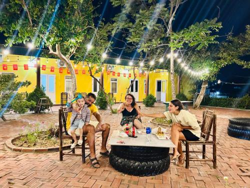 a group of people sitting around a table in a patio at Cô Tô Lương Chi in Quang Ninh