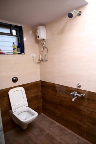a bathroom with a toilet and a phone on the wall at 2 BHK Villa in Wada in Pālghar