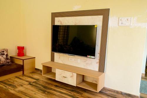 a living room with a flat screen tv on a wall at 2 BHK Villa in Wada in Pālghar