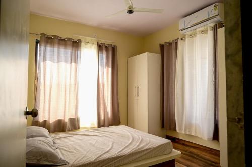 a bedroom with a bed and a window at 2 BHK Villa in Wada in Pālghar