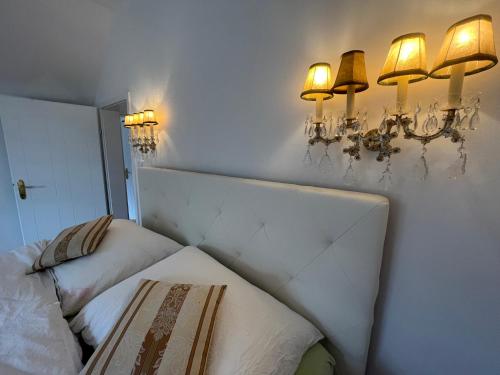 a room with two beds and lights on the wall at Villa Bella Vita in Seeboden