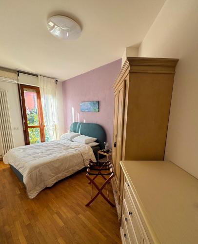 a bedroom with a bed with a blue headboard at La Casa Blu Rimini in Rimini
