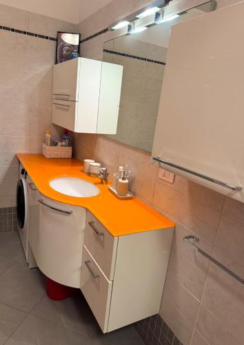 a bathroom with a sink and a mirror at La Casa Blu Rimini in Rimini