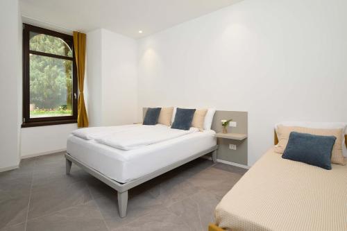 a white room with a couch and a window at Appartamento ai giardini in Arco
