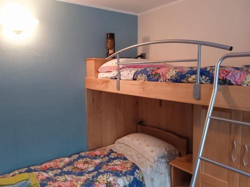 a bedroom with two bunk beds and a bed at Cotto's house in Gerola Alta