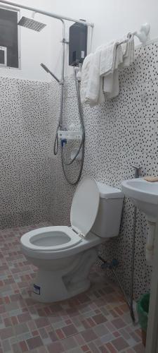 a bathroom with a toilet and a sink at GGGO RESIDENCES, Studio 103, King in Sorsogon