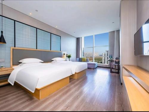 Katil atau katil-katil dalam bilik di Echarm Hotel Wuhan Jiangxia Cultural Avenue Zhongbai Plaza