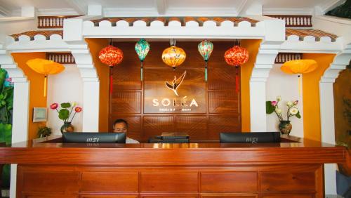 a man sitting at a desk in a court room at Soléa Hotel & Serviced Apartment Sunset Town Phu Quoc in Phu Quoc