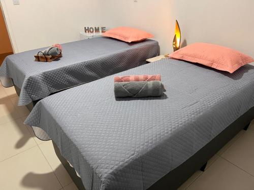two beds sitting next to each other in a room at Pousada Nova Era in Galinhos