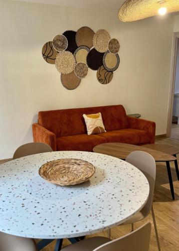 un salon avec une table et un canapé dans l'établissement Le cocon coloré - Appartement centre ville, à Lourdes