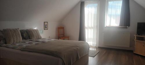 a bedroom with a bed and a television in it at Casa Dancs in Covasna