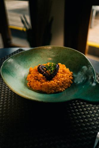 a green plate with a piece of food on it at Hiu Hotel in Juquei