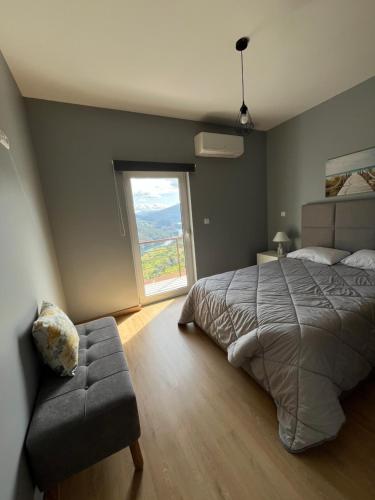 a bedroom with a large bed and a window at Casa Pereira in Geres