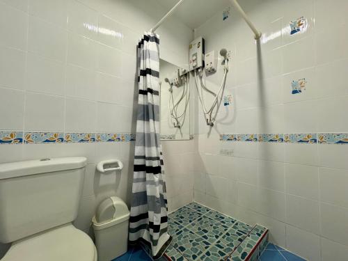 a bathroom with a toilet and a shower at Ananas Central Phuket Hostel in Ban Ket Ho