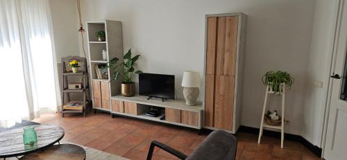 a living room with a tv sitting on a shelf at Spekenbrink in Haaksbergen