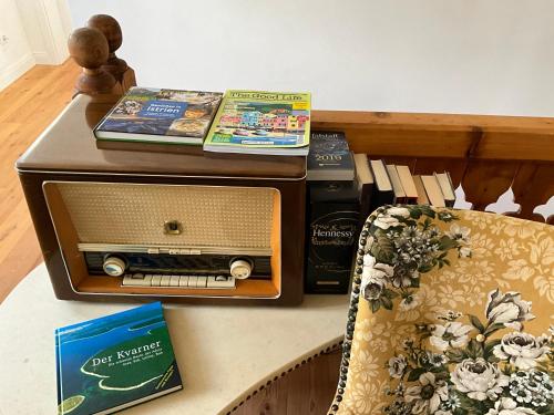 an old radio sitting on a table next to a chair at Villa Bella Vita in Seeboden