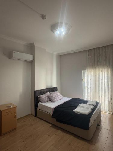 a bedroom with a large bed and a window at Antalya Apart in Antalya