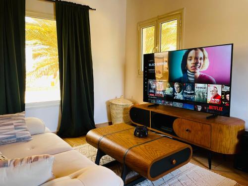 a living room with a large flat screen tv at Villa Vovan in Dahab