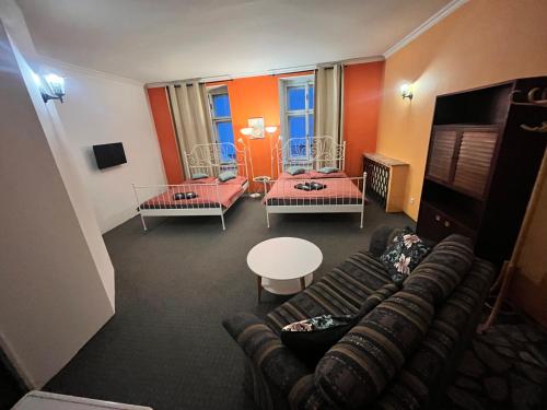 a living room with a couch and a table at Penzion V Centru in Prostějov