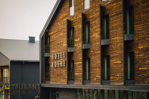 a brick building with windows on the side of it at Hotel Roshe Gudauri in Gudauri