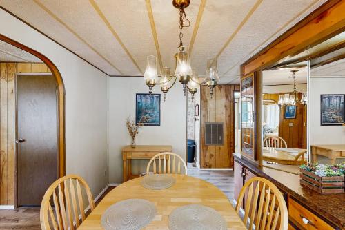 a dining room with a wooden table and chairs at Redwood Coast River House in Smith River
