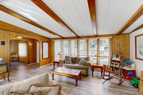 a living room with a couch and a table at Redwood Coast River House in Smith River