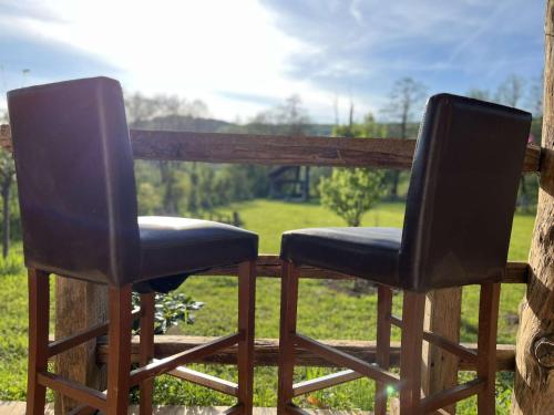 two chairs sitting next to each other on a porch at Edenski vrt in Ivančna Gorica
