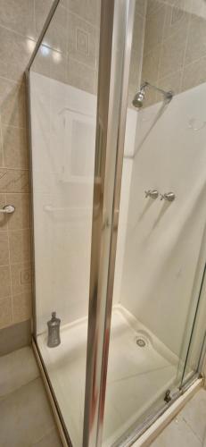 a shower with a glass door in a bathroom at Budget Friendly Couple Room Esperance in Esperance