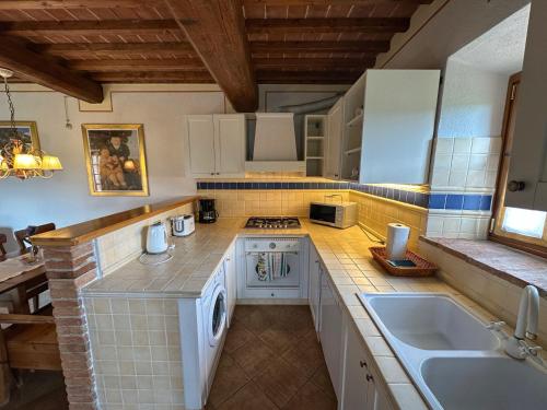 una cocina con fregadero y estufa horno superior en Agriturismo Borgo 7 Tigli - APT 2, en Montepulciano