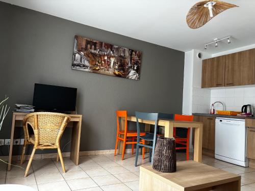 une cuisine avec une table et des chaises ainsi qu'une salle à manger dans l'établissement Cottage 102, à Saumur