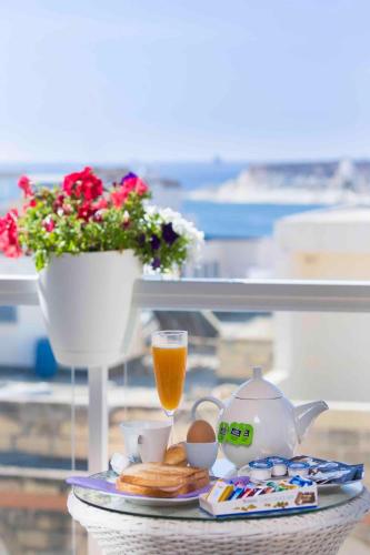 a tray of food with a teapot and a cup of tea at Sea View 2 Bed Apartment close to beach Hpi6768 in Il-Maħsel